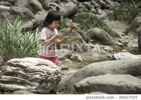 Little girl eating sausage 30827505