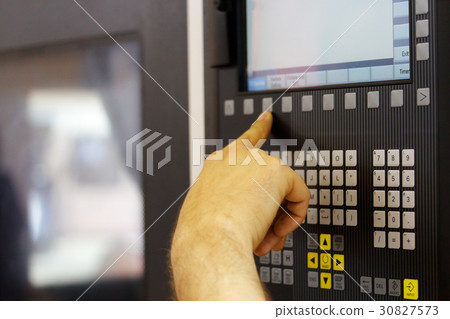 operator working with cnc machine 30827573