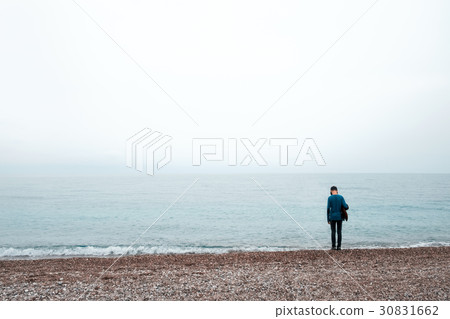 Alone boy stay near sea 30831662