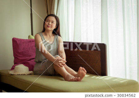 Woman relaxing on sofa 30834562