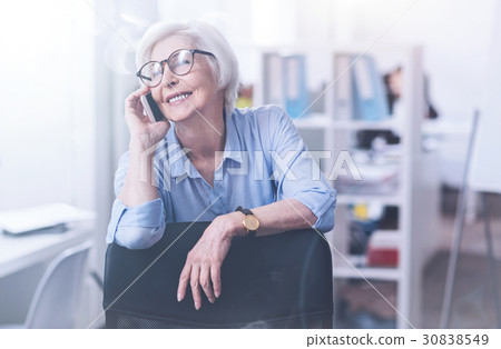 Relaxed mature woman having telephone call Relaxed mature woman having telephone call 30838549