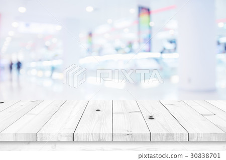 Wood table with blur shopping mall background. Wood table with blur shopping mall background. 30838701