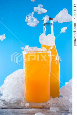 bottle of orange soda with glass and ice on a wood bottle of orange soda with glass and ice on a wood 30841016