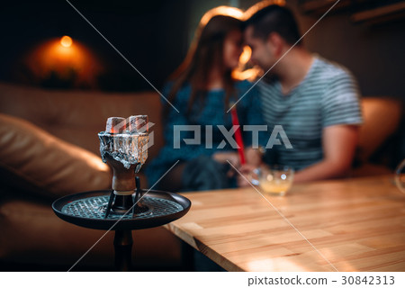 Young couple relax and smoking hookah Young couple relax and smoking hookah 30842313