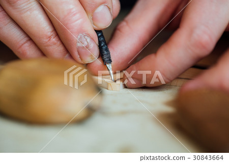Master artisan luthier working on the creation of Master artisan luthier working on the creation of 30843664
