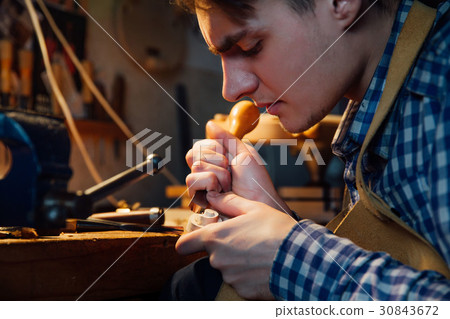 Master artisan luthier working on the creation of 30843672