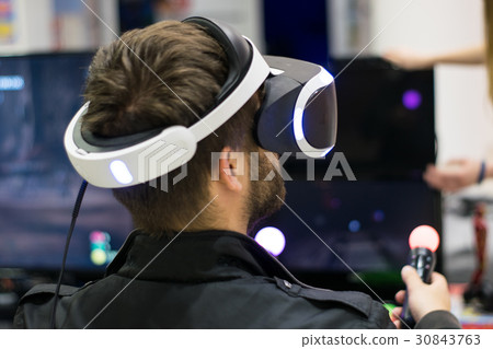 Young man using the virtual reality headset.  30843763