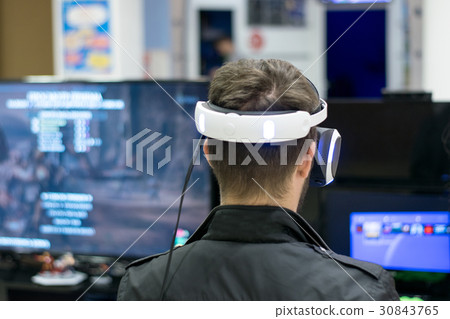 Young man using the virtual reality headset.  30843765