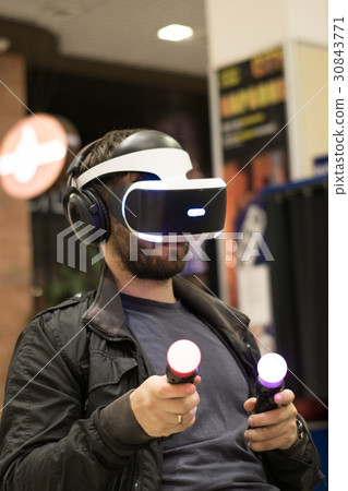 man in VR headset with joysticks 30843771