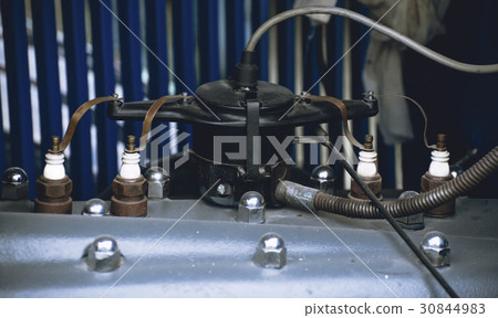 Spark plugs and ignition distributor of an old car 30844983