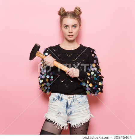 cute girl holding heavy hammer in hands 30846464