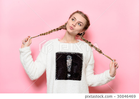 Beautiful cute girl having fun holding pigtails 30846469