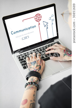 Woman connected with global communications network by laptop 30851689