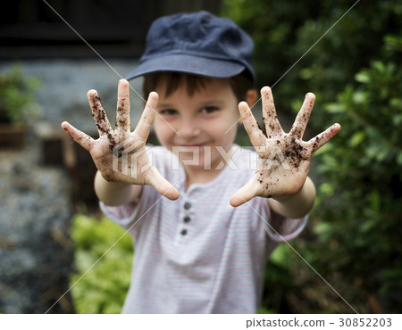 Kid is in a garden 30852203