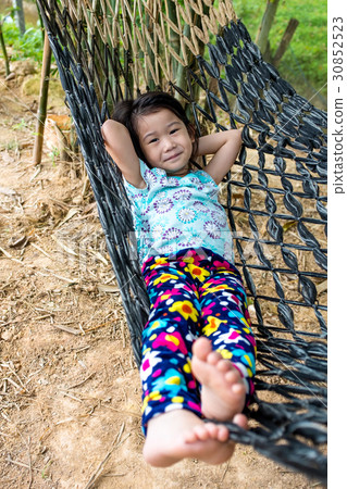 Cheerful child enjoying and relaxing in hammock. 30852523