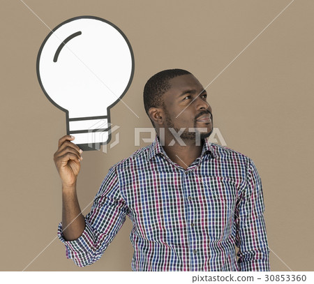 African Descent man holding light bulb African Descent man holding light bulb 30853360