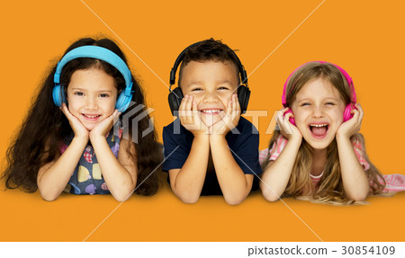 Diverse Group Of Kids Lying and Listen to Music In a Headphones Diverse Group Of Kids Lying and Listen to Music In a Headphones 30854109