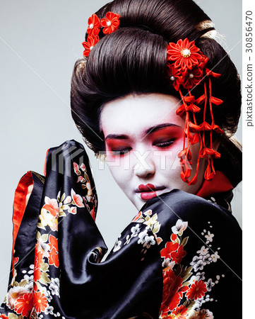 young pretty geisha in black kimono among sakura 30856470