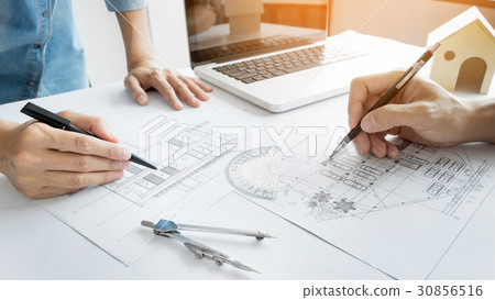Architects engineer discussing at the table with blueprint - Clo 30856516