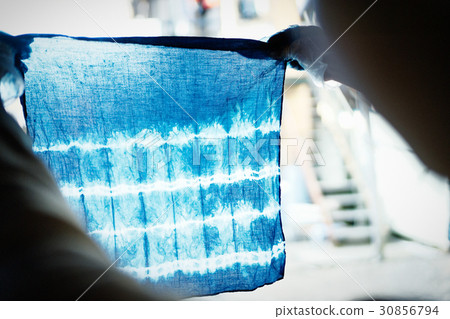 A woman watching a tie dye finish A woman watching a tie dye finish 30856794