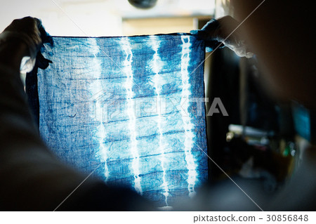 A woman watching a tie dye finish A woman watching a tie dye finish 30856848