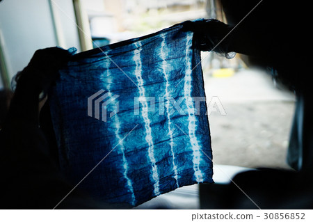 A woman watching a tie dye finish A woman watching a tie dye finish 30856852
