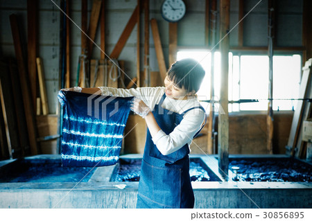 A woman watching a tie dye finish 30856895