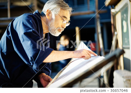 Indigo dye hand drying 30857046