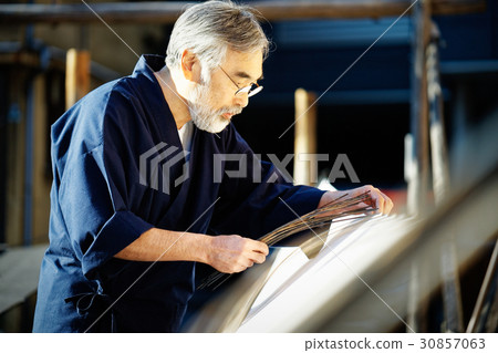 Indigo dye hand drying 30857063