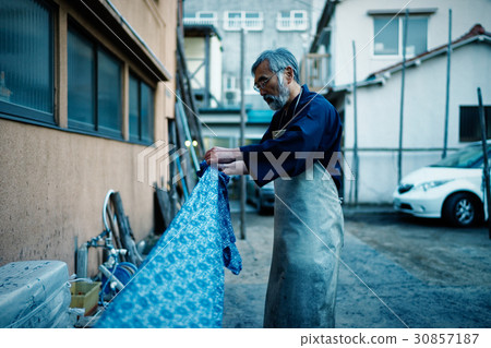 Indigo dye hand drying 30857187