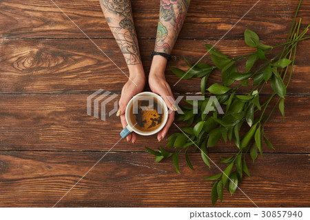 Female hands holding tea cup Female hands holding tea cup 30857940