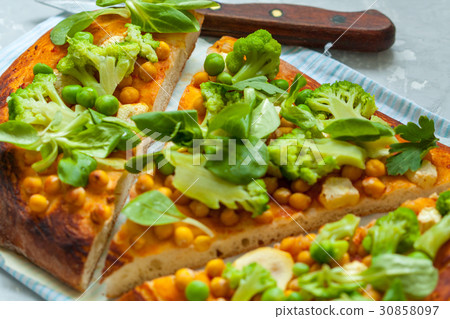 Vegan pizza with chickpeas and broccoli. 30858097