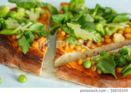 Vegan pizza with chickpeas and broccoli. Vegan pizza with chickpeas and broccoli. 30858104
