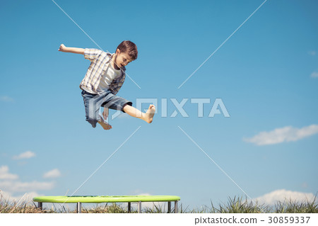 Little boy playing on the field at the day time. Little boy playing on the field at the day time. 30859337