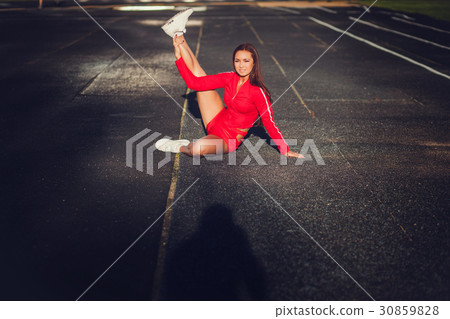 Fit woman stretching her leg Fit woman stretching her leg 30859828