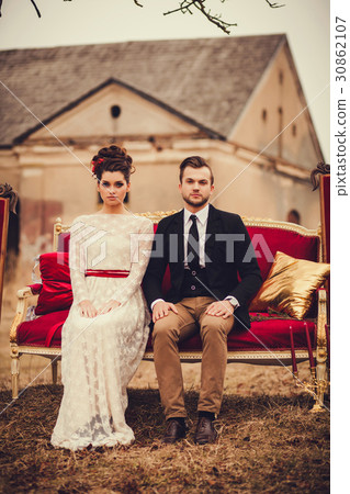 Romantic couple sitting on the couch 30862107