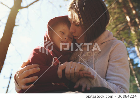 Young mother hugging her little son 30864224