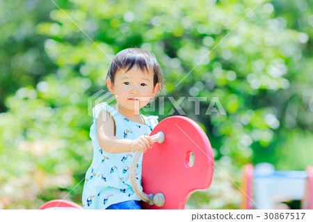 Cute child playing with park play equipment Cute child playing with park play equipment 30867517