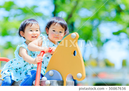 Cute child playing with park play equipment 30867636