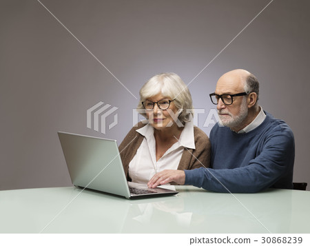 Senior couple looking at laptop Senior couple looking at laptop 30868239