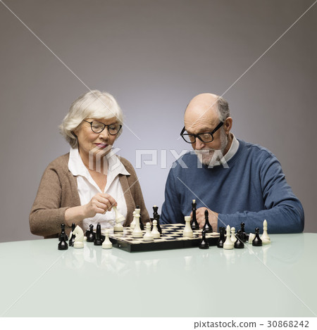 Elderly couple playing chess Elderly couple playing chess 30868242