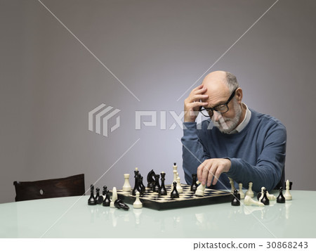 Senior man thinking over chess Senior man thinking over chess 30868243