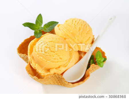 orange ice cream in a waffle basket 30868368