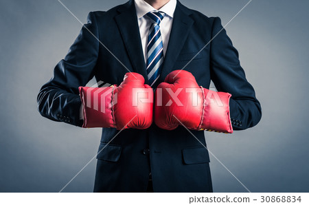 A businessman with a boxing glove 30868834