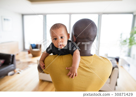 Young afro-american father holding his baby son in Young afro-american father holding his baby son in 30871429