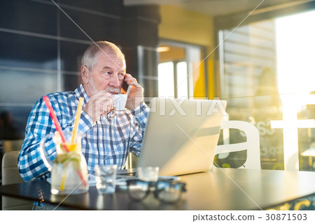Senior businessman with smartphone and laptop in Senior businessman with smartphone and laptop in 30871503