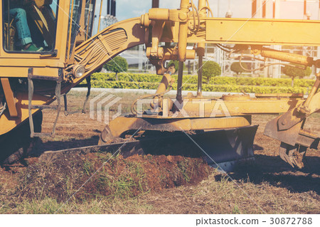 Grader leveling landfill on construction site Grader leveling landfill on construction site 30872788