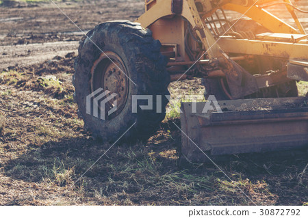 Grader leveling landfill on construction site Grader leveling landfill on construction site 30872792