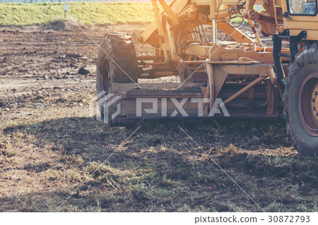 Grader leveling landfill on construction site Grader leveling landfill on construction site 30872793
