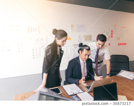Serious business working in office using laptop 30873217